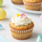Easter-themed baked treats including muffins, bunny-shaped cookies, and colorful decorations on a festive table.