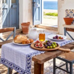 Mediterranean-inspired home decor with ceramic bowls, vases, rugs, and warm lighting creating a cozy interior atmosphere