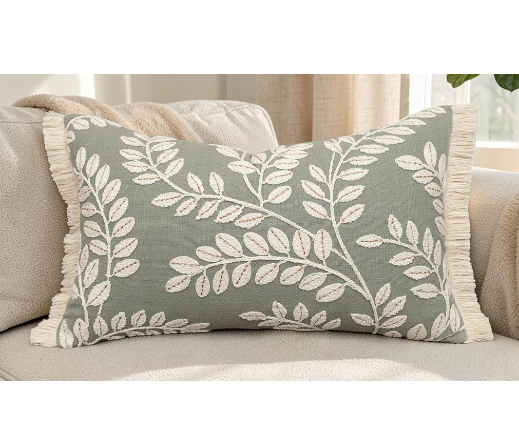 Sage green botanical vine embroidered lumbar pillow cover with fringe trim for reading nook