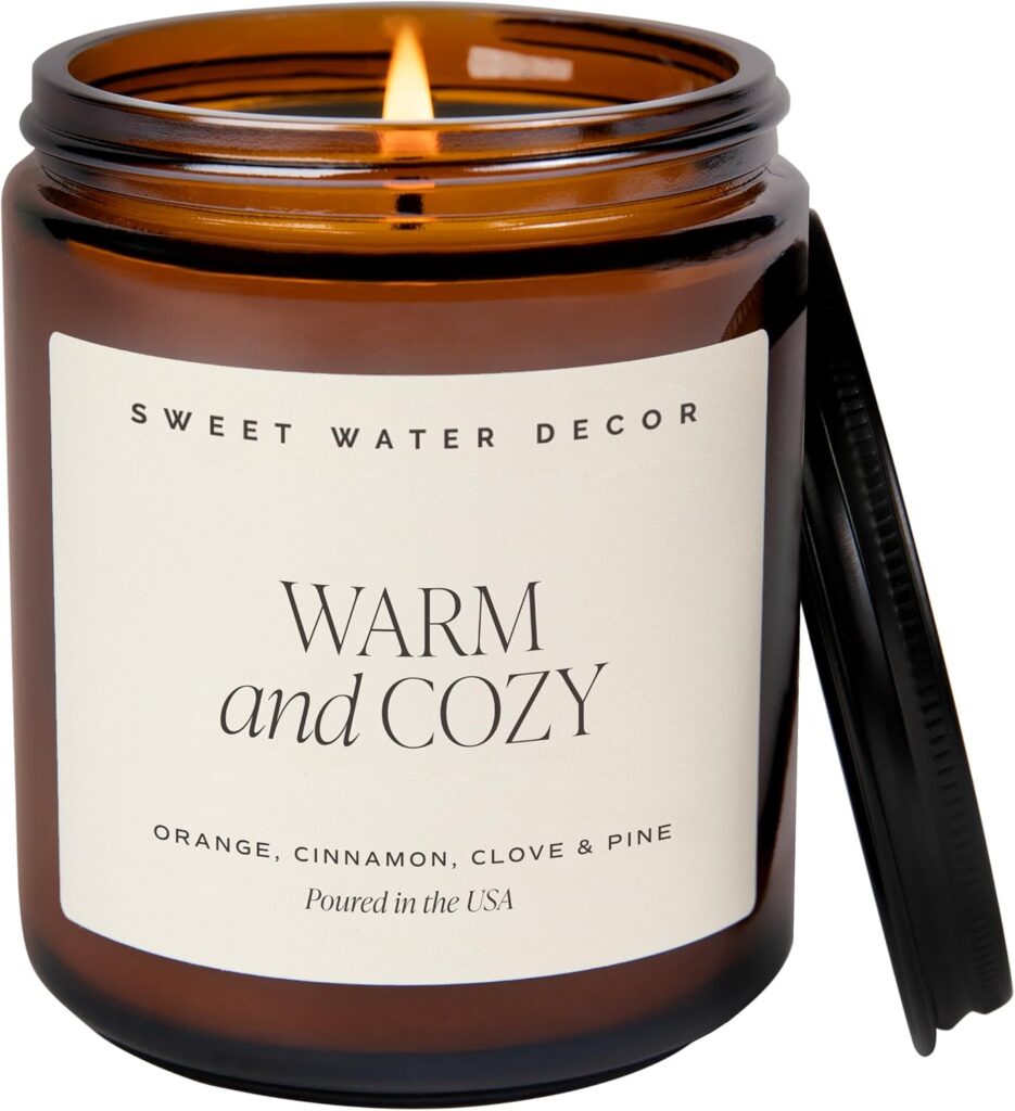 Sweet Water Decor warm and cozy amber glass candle with orange peel cinnamon and clove